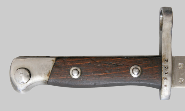 Image of the hilt from a Chilean M1895 bayonet, showing the coil spring press stud.
